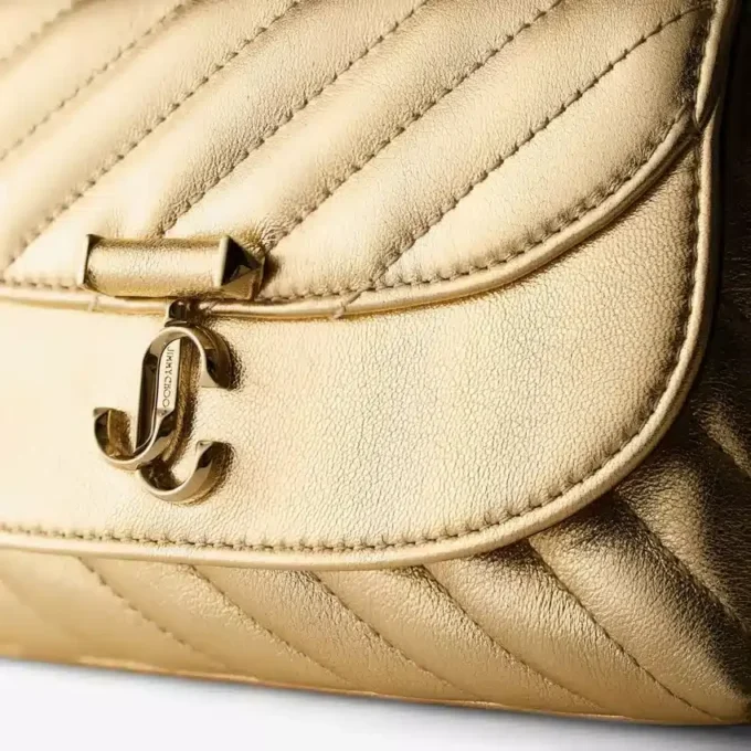 Curve Cross Body Small Goudkleurige gewatteerde metallic nappalederen crossbodytas Curve Cross Body Small Goudkleurige gewatteerde metallic nappalederen crossbodytas