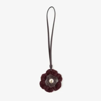Gebreide bloemenbedel Diep merlotkleurige gebreide wollen bloemenbedel met leren afwerking