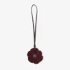 Gebreide bloemenbedel Diep merlotkleurige gebreide wollen bloemenbedel met leren afwerking Gebreide bloemenbedel Diep merlotkleurige gebreide wollen bloemenbedel met leren afwerking
