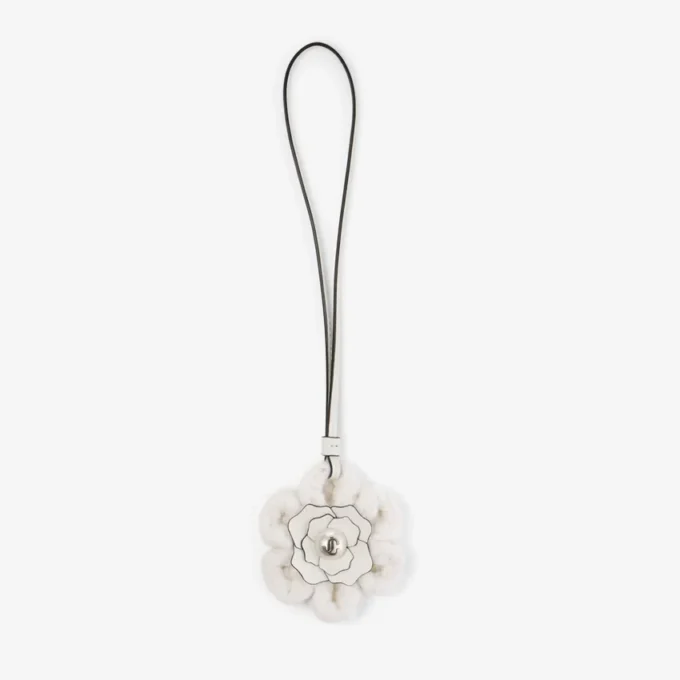 Gebreide bloemenbedel Latte Gebreide wollen bloemenbedel met leren afwerking