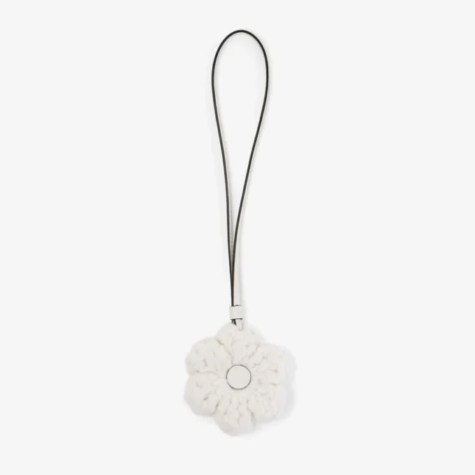 Gebreide bloemenbedel Latte Gebreide wollen bloemenbedel met leren afwerking