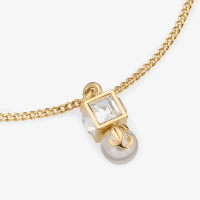 Jc Pearl Cube-armband Gouden metalen armband met parel en kristallen kubus Jc Pearl Cube-armband Gouden metalen armband met parel en kristallen kubus